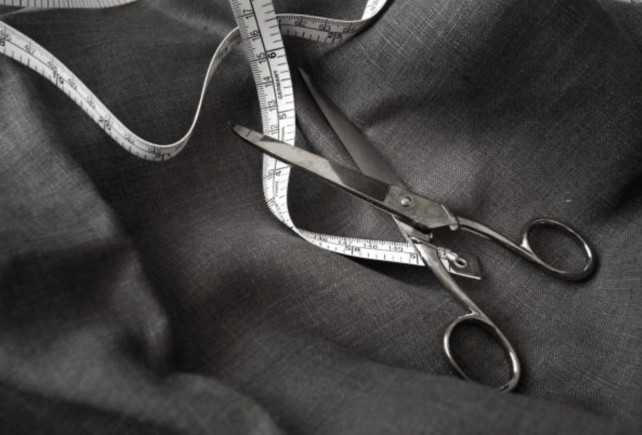 worsted cloth with tailors sheers and a tape measure